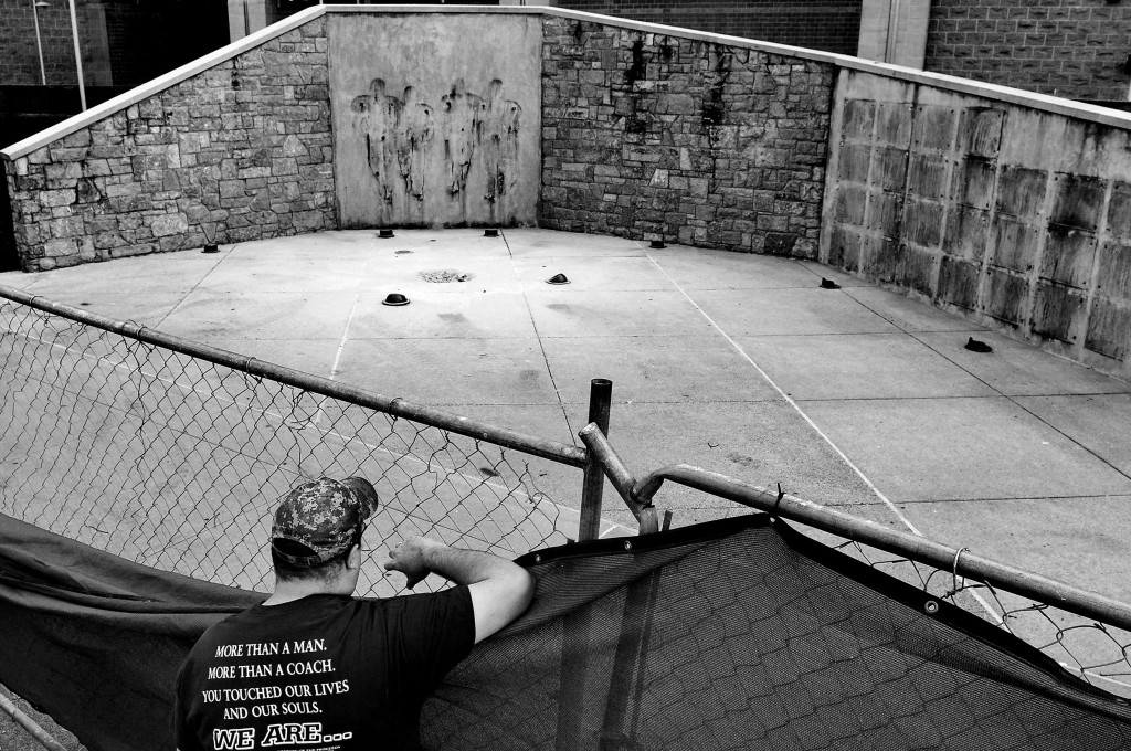 A man stares at the site in which the statue of former Penn State University football coach Joe Paterno stood now sits empty after it was removed six months after his death by workers outside Beaver Stadium on July 22, 2012 in State College, Pennsylvania. In the worst scandal in the history of college sports, Penn State's president Rodney Erickson made the decision Sunday to remove the statue in the wake of the child sex scandal because it was believed that Paterno had detailed knowledge of Jerry Sandusky sexually abusing children before and after Sandusky retired from coaching at Penn State. The same day, the NCAA also imposed unprecedented penalties against the Penn State football program for its involvement in the sexual abuse scandal that centered on Sandusky.