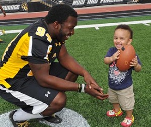 Eden Turner plays with Towson football's Tungie Coker at Johnny Unitas Stadium.