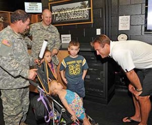 TU football coach Rob Ambrose, right, meets with members of the Maryland National Guard and their children.