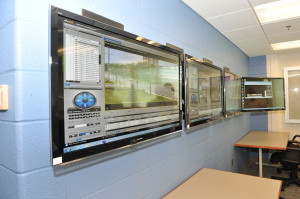 Monitors in the conference room allow checks on locations throughout campus