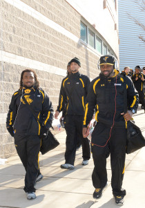 Towson running backs Darius Victor, left, and Terrance West and the Tigers board buses for their trip to Charleston, Ill.