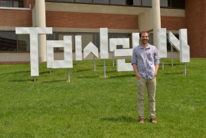 Nicholas Edwards in front of the sculpture