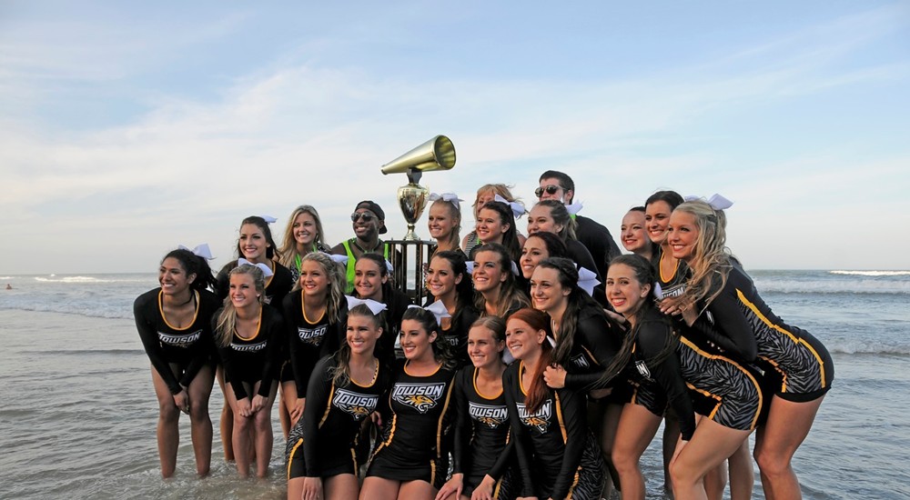The Towson University Cheerleading Squad celebrate on the beach after winning their second NCA National Championship. 