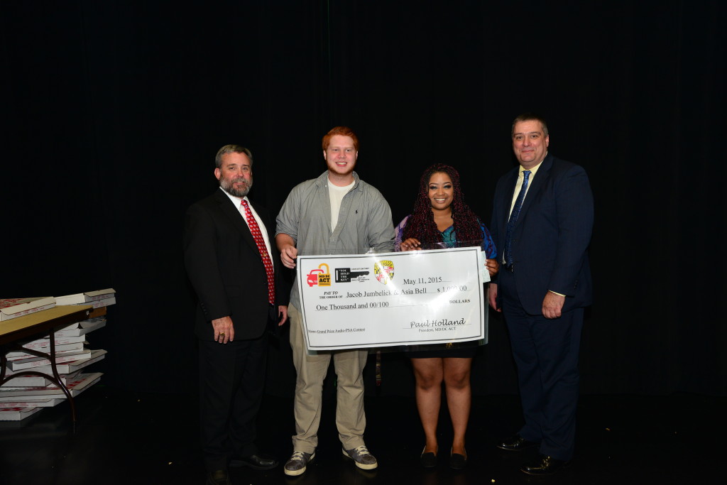 Paul Holland '83, MD/DC Anti-Car Theft Committee along with Christopher T. McDonald, Deputy Director, Maryland Vehicle Prevention Council, present Jacob Jumbelick '17 and Asia Bell '15 with the grand prize audio PSA award. 