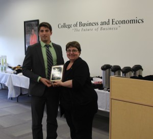 Senior David Bronson receives the second place award from marketing department chair Judy Harris.