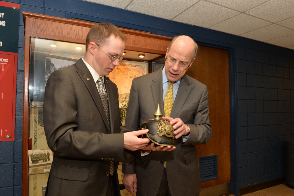 Acting President Chandler examines an artifact from the display