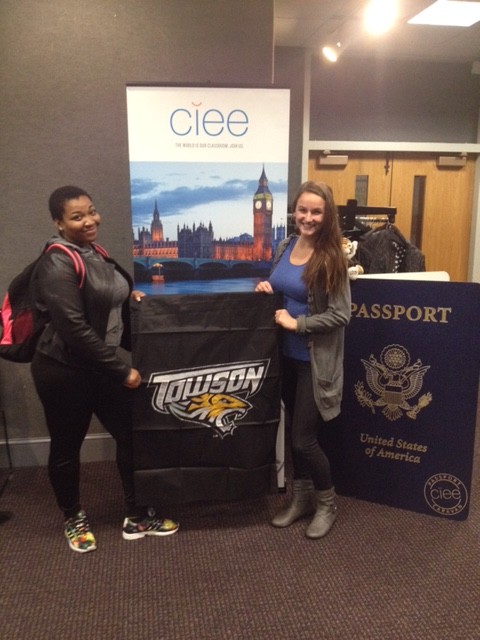 Two female students with a Towson flag
